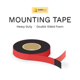 Heavy duty double sided foam mounting tape roll with the red protective liner peeled back from the black foam